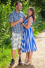 Happy attractive couple in love, man wearing a prosthetic leg.