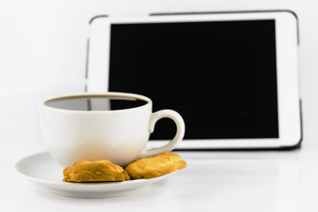 cup of coffee with cookie and tablet computer isolated on white