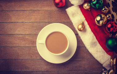Cup of coffee and gifts at background
