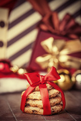 Cookies with christmas gifts on wooden table