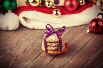 Cookies with christmas gifts on wooden table