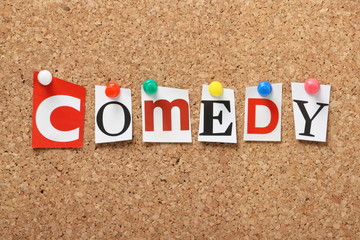 The word Comedy on a cork notice board