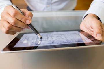 Architect working with stylus and digital tablet pc