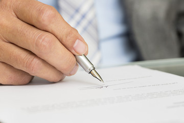 Businessman is Signing a Contract, focus on pen