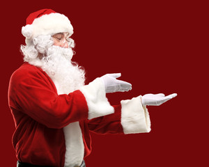 Santa Claus with his arms out in a presenting gesture