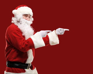 Fototapeta na wymiar Santa Claus with his arms out in a presenting gesture