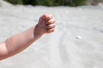 Hand throws sand