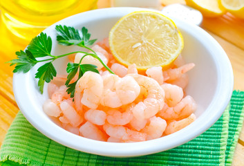 boiled shrimps in the white bowl on the table