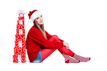 smiling woman in Santa hat with many gift boxes