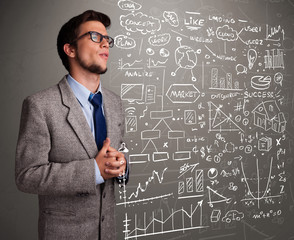 Attractive man looking at stock market graphs and symbols