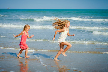 Happy kids playing at the beach