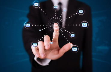 Businessman pressing virtual messaging type of icons