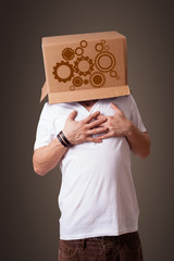 Young man gesturing with a cardboard box on his head with spur w