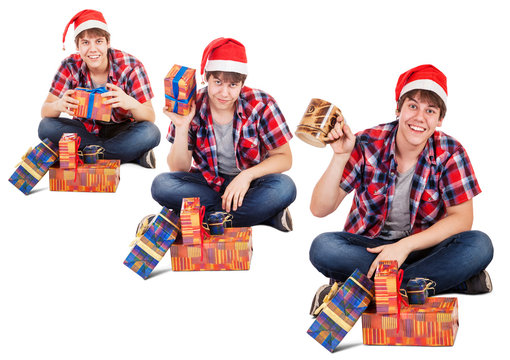 Cheerful young man dressed in santa hat found gift in box