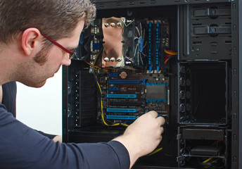 Fototapeta na wymiar Male technician repairing computer at store