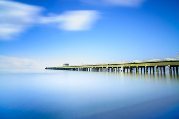 Fototapeta na wymiar Industrial pier on the sea. Side view. Long exposure