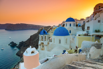 Sunset over the churches of Oia village, Santorini, Greece