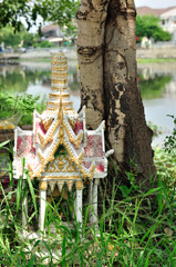 Fototapeta premium shrine of the household god beside tree.