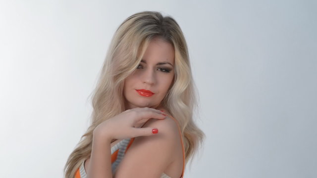 Young blond girl posing in studio