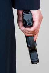 Woman holding hand gun on white background