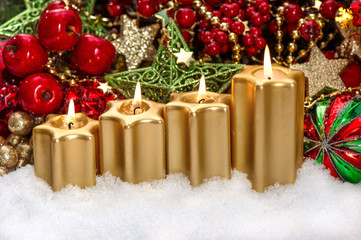 advent composition with four burning golden candles