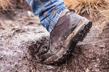 Side view of an hiking shoe covered in mud - 58542288