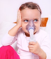 Little girl making aerosol treatment for lung diseases