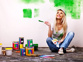 Woman paint wall at home. - obrazy, fototapety, plakaty