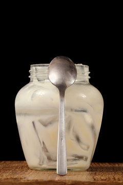 Empty yorgurt jar with a spoon