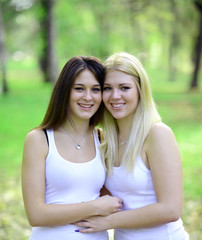 Close up portrait of two happy women looking at camera and smili