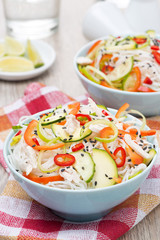 Thai salad with vegetables, rice noodles and chicken, close-up