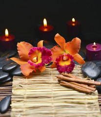Fototapeta na wymiar Spa resort -candle with orchid and pebbles