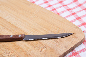 knife on the table with checkered tablecloth