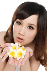 Obraz na płótnie Canvas Young girl holding frangipani flower in her hand