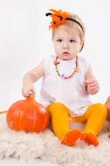 Baby girl with pumpkin