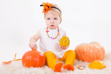 Baby girl with pumpkin