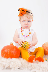 Baby girl with pumpkin
