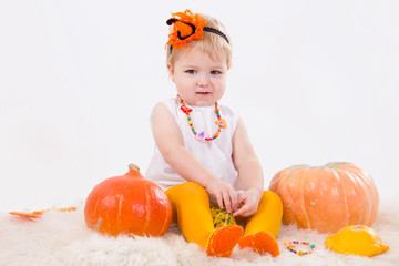 Baby girl with pumpkin