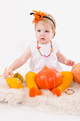 Baby girl with pumpkin