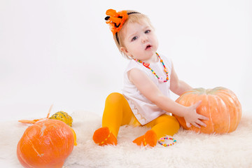 Baby girl with pumpkin