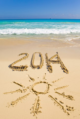 2014 inscription on the sand near the sea...