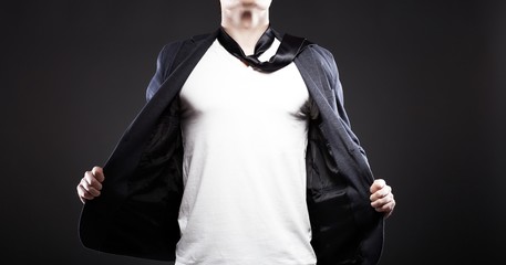 Man pulling open jacket showing white t shirt, copyspace