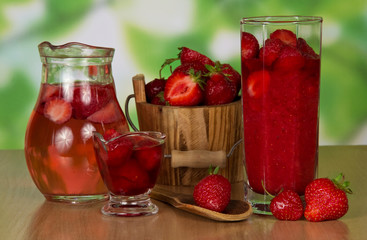 Jug with drink and strawberry in a bucket