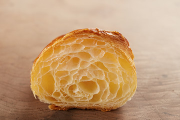Butter croissant interior close-up on wooden table
