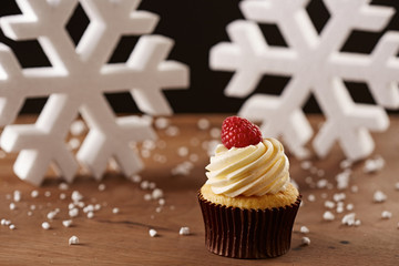 Raspberry cupcake on Christmas background