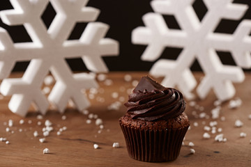Black chocolate cupcake on Christmas background