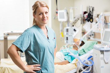 Confident Nurse With Patient Resting In Background