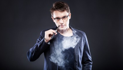 Young man smoking electronic cigarette