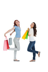 Obraz premium Two happy young female friends with shopping bags