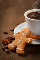 Coffee with gingerbread man  on a wooden background